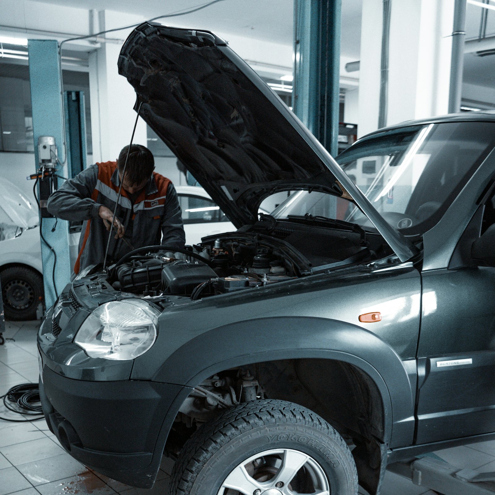 Car with the bonnet up in the workshop